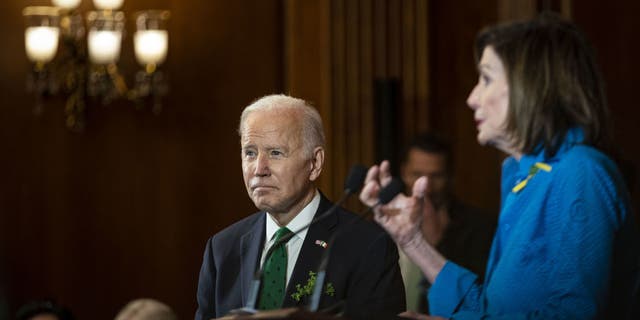 President Joe Biden listens as House Speaker Nancy Pelosi, D-Calif., speaks at the annual Friends of Ireland Luncheon at the Capitol in Washington, DC, March 17, 2022.