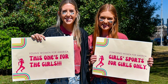 Members of Young Women For America protest transgender swimmer Lia Thomas at the NCAA Swimming and Diving Championships on March 17, 2022, in Atlanta Georgia.