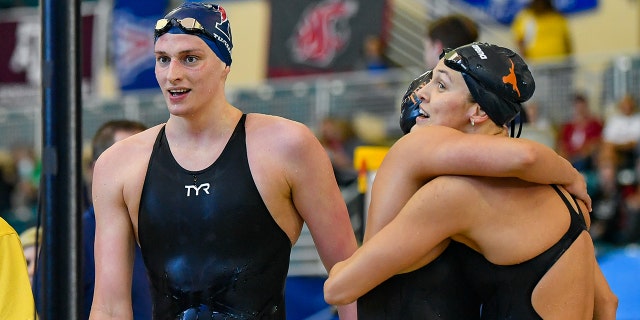 Texas swimmers Erica Sullivan and Evie Pfeifer embrace as 500 Freestyle winner Lia Thomas walks past during the NCAA Swimming and Diving Championships on March 17th, 2022 at the McAuley Aquatic Center in Atlanta Georgia.