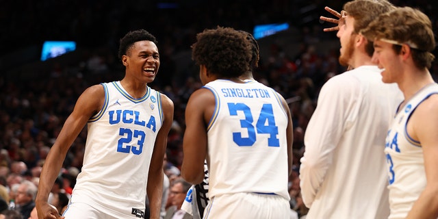 Peyton Watson #23 of the UCLA Bruins smiles at the bench as the UCLA Bruins take on the St. Mary's Gaels during the second round of the 2022 NCAA Men's Basketball Tournament held at the Moda Center on March 19, 2022 in Portland, Oregon. 