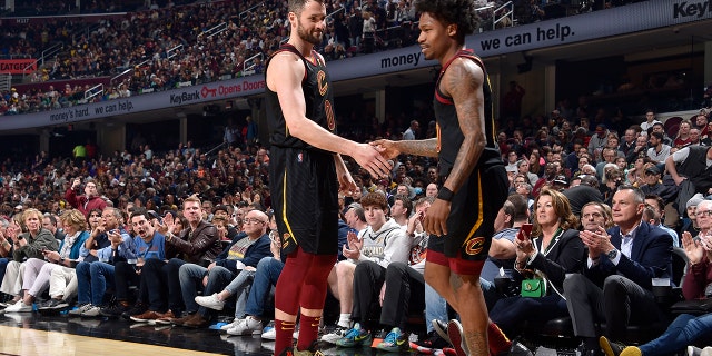 Kevin Love #0 of the Cleveland Cavaliers high fives Brandon Goodwin #00 of the Cleveland Cavaliers during the game against the Los Angeles Lakers on March 21, 2022, at Rocket Mortgage FieldHouse in Cleveland, Ohio.