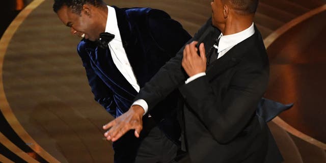 Will Smith slaps Chris Rock onstage during the 94th Oscars at the Dolby Theatre in Hollywood, California on March 27, 2022. (Photo by ROBYN BECK/AFP via Getty Images)