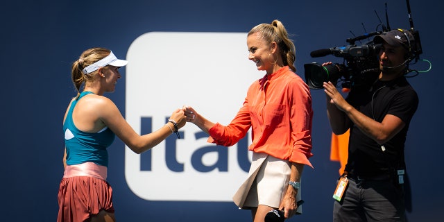 Linda Fruhvirtova of the Czech Republic fist-bumps former player and TV presenter Daniela Hantuchova after defeating Victoria Azarenka of Belarus in her third-round match of the Miami Open at Hard Rock Stadium on March 27, 2022, in Miami Gardens, Florida.