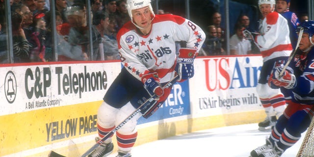 Dmitri Khristich #8 #35 of the Washington Capitals skate with the puck during a NHL hockey game on Dec. 16, 1995 at USAir Arena in Landover, Maryland.