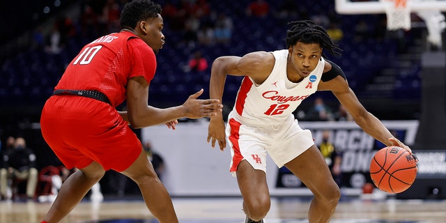 Tramon Mark #12 of the Houston Cougars dribbles against Montez Mathis #10 of the Rutgers Scarlet Knights during the second half in the second round game of the 2021 NCAA Men's Basketball Tournament at Lucas Oil Stadium on March 21, 2021 in Indianapolis, Indiana. 