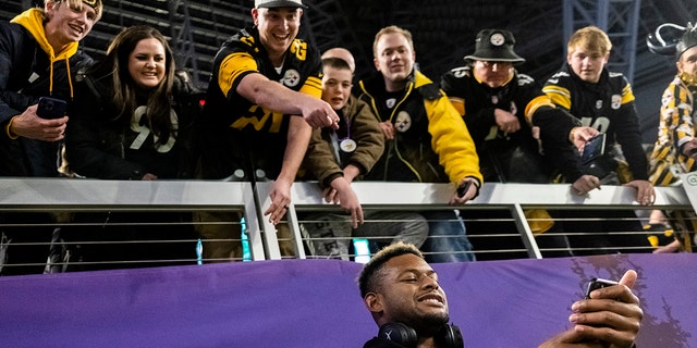 JuJu Smith-Schuster #19 of the Pittsburgh Steelers poses for a photo with fans before the game against the Minnesota Vikings at US Bank Stadium on December 9, 2021 in Minneapolis, Minnesota.