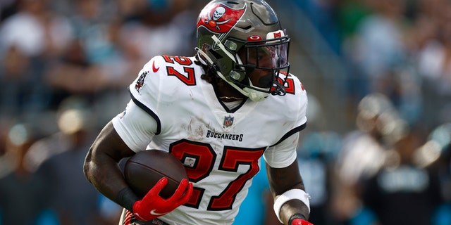 Ronald Jones #27 of the Tampa Bay Buccaneers carries the ball during the first half of the game against the Carolina Panthers at Bank of America Stadium on December 26, 2021 in Charlotte, North Carolina.