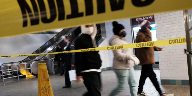 NEW YORK, NEW YORK - JANUARY 19: People walk through a subway station in Manhattan on January 19, 2022 in New York City. The New York City subway system, the nation's largest, has come under increasing scrutiny following the violent death of a 40-year old woman last week in the Times Square subway station.
