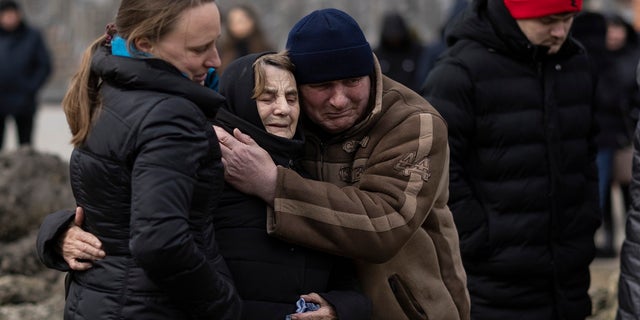 Mourners react during a funeral service for two Ukrainian soldiers at Lychakiv cemetery on March 8, 2022, in Lviv, Ukraine. 