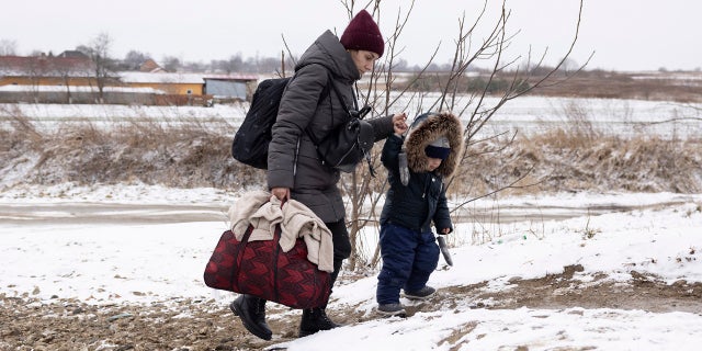 Refugees make their way to the border crossing with Poland on March 9, 2022, in Krakovets, Ukraine.