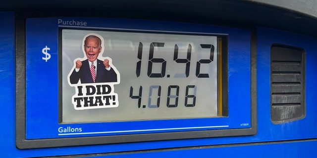 A sticker of President Joe Biden is placed on a gas pump at an Exxon Station on March 9, 2022 in Lakewood, Colorado.