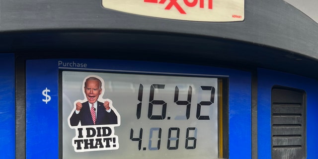 A sticker of President Joe Biden is placed on a gas pump at an Exxon Station