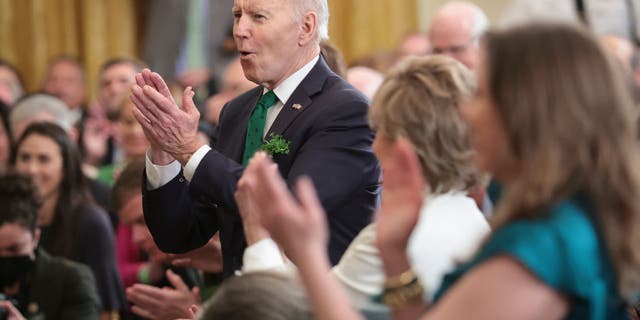 President Joe Biden applauds for entertainers who performed during an event celebrating St. Patrick’s Day in the East Room of the White House March 17, 2022, in Washington, D.C. (Photo by Win McNamee/Getty Images)