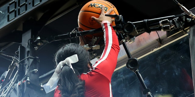 A cheerleader retrieves the ball after it became stuck on top of the backboard in the first round game between the St. Mary's Gaels and the Indiana Hoosiers in the 2022 NCAA Men's Basketball Tournament at Moda Center on March 17, 2022 in Portland, Oregon.