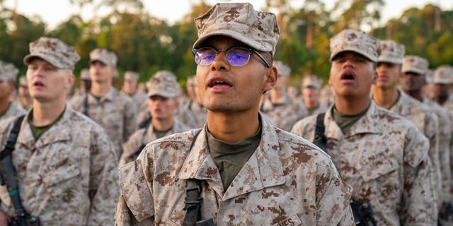 US Marine Corps recruits take part in the traditional Eagle, Globe and Anchor medal ceremony. (Photo by Robert Nickelsberg/Getty Images)
