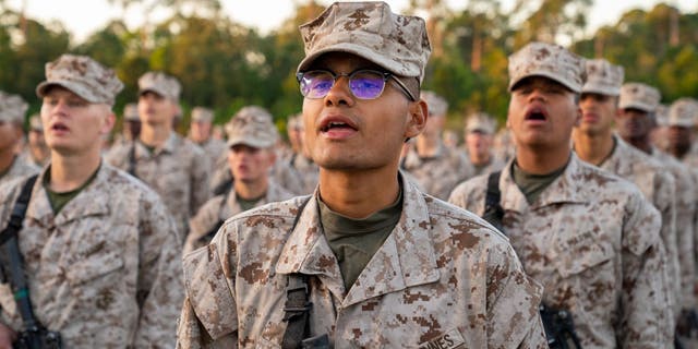 US Marine Corps recruits take part in the traditional Eagle, Globe and Anchor medal ceremony. (Photo by Robert Nickelsberg/Getty Images)