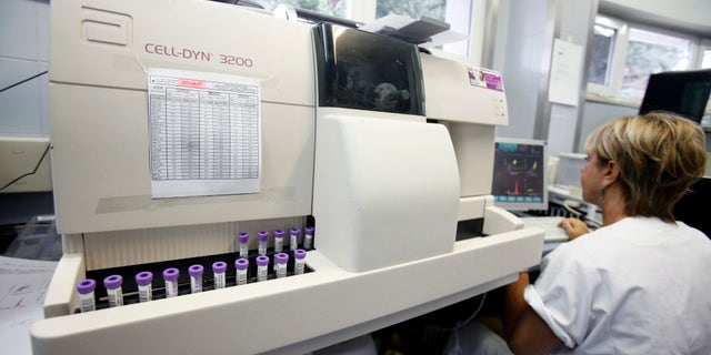 A biologist uses a Cell-Dyn 3200 analyzer, manufactured by Abbott Laboratories, to test blood samples in the medical laboratory of the Casa di Cura San Feliciano hospital in Rome, Italy, on Monday, July 23, 2012.