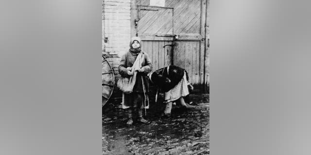 Two peasant women collecting fallen grain on a collective farm near Belgorod, during the man-made Holodomor famine in the Ukraine 1934. (Daily Express/Hulton Archive/Getty Images)