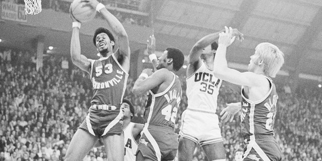 Artis Gilmore (53) of the Jacksonville University Dolphins grabs a rebound in the final of an NCAA Tournament against UCLA. 