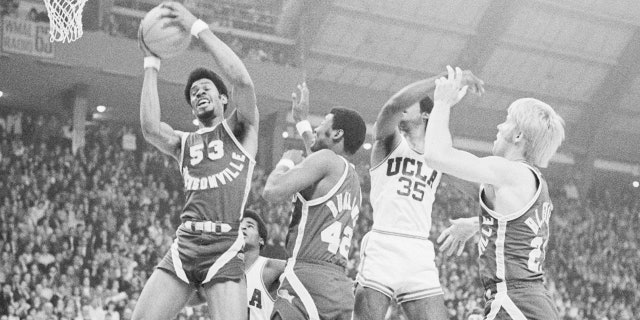 Artis Gilmore (53) of the Jacksonville University Dolphins grabs a rebound during the finals of an NCAA tournament against UCLA. 