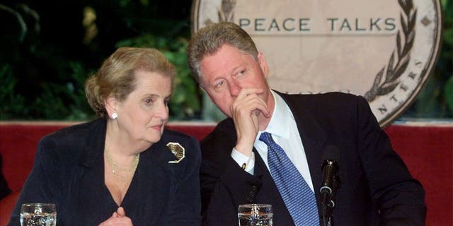 Former Secretary of State Madeleine Albright talks with former President Bill Clinton on Oct. 14, 1998.
