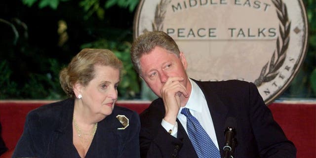 Former Secretary of State Madeleine Albright talks with former President Bill Clinton on Oct. 14, 1998.