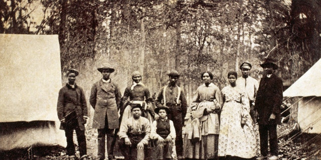 Group of freed slaves who worked as laborers and servants with the 13th Massachusetts Infantry Regiment during the American Civil War, 1862.
