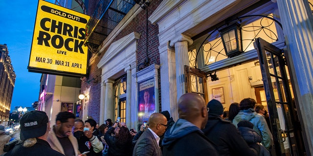People enter The Wilbur for a sold-out performance by Chris Rock in Boston, Massachusetts on March 30, 2022.