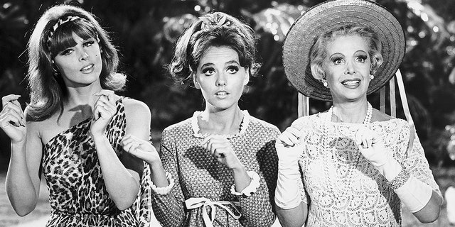 From left to right, sex-kitten Ginger (Tina Louise), girl-next-door Mary Ann (Dawn Wells), and millionairess Mrs. Howell (Natalie Schaefer) in a scene from the 1960s television comedy "Gilligan's Island."