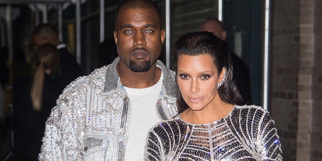 Rapper Kanye West (left) and TV personality Kim Kardashian attend 