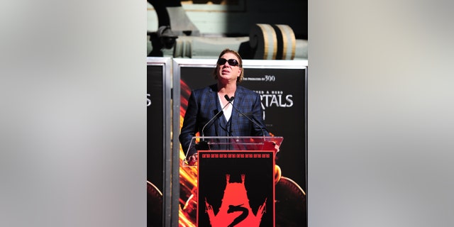 Actor Mickey Rourke looks up to the sky as he remembers his grandmother at his hand and footprint ceremony in front of Grauman's Chinese Theater in Hollywood, California, on Oct. 31, 2011.