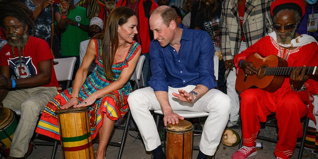 Prince William, Duke of Cambridge and Catherine, Duchess of Cambridge play drums during a visit to Trench Town Culture Yard Museum where Bob Marley used to live, on day four of the Platinum Jubilee Royal Tour of the Caribbean on March 22, 2022, in Kingston, Jamaica. The Duke and Duchess of Cambridge are visiting Belize, Jamaica, and The Bahamas on their week-long tour.