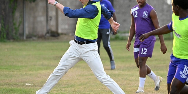 Prince William, Duke of Cambridge plays football during a visit to Trench Town, the birthplace of reggae music, on day four of the Platinum Jubilee Royal Tour of the Caribbean on March 22 in Kingston, Jamaica.