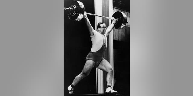 Russian heavyweight weightlifter Yuri Vlasov in action during the World Championships which he won to achieve the official title of the strongest man in the world, circa 1962.