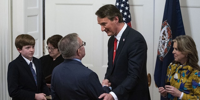 Glenn Youngkin, governor of Virginia, center, greets Andrew Wheeler, Virginia's incoming secretary of natural resources, during a cabinet swearing-in ceremony at the Virginia Executive Mansion in Richmond, Virginia, U.S., on Saturday, Jan. 15, 2022. Photographer: Al Drago/Bloomberg via Getty Images