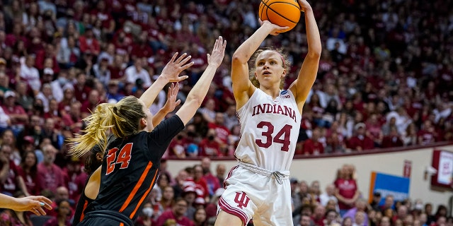 Indiana guard Grace Berger (34) shoots over Princeton guard Julia Cunningham (24) in the second half of a college basketball game in the second round of the NCAA tournament in Bloomington, Ind., Monday, March 21, 2022. Indiana defeated Princeton 56-55.