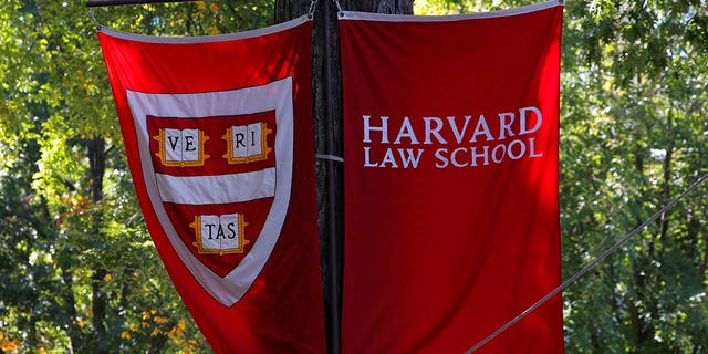 Banners for Harvard Law School fly during the inauguration of Lawrence Bacow as the 29th President of Harvard University in Cambridge, Massachusetts.