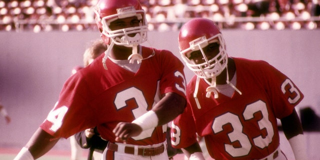 Running backs Herschel Walker (34) and Maurice Carthon (33) of the New Jersey Generals stretch before the game against the Memphis Showboats of the United States Football League (USFL) at Giants Stadium on June 1, 1985, in East Rutherford, New Jersey.
