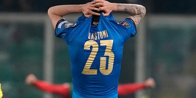 North Macedonia players celebrate as Italy's Alessandro Bastoni reacts after his team's got eliminated at the end of the World Cup qualifying play-off soccer match between Italy and North Macedonia, at Renzo Barbera stadium, in Palermo, Italy, Thursday, March 24, 2022. North Macedonia won 1-0.