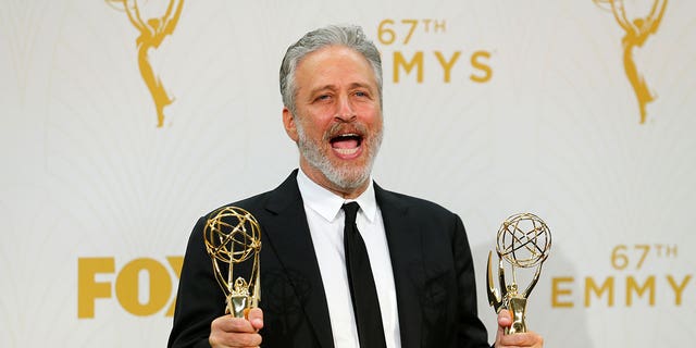 Jon Stewart holds his awards for Outstanding Writing For A Variety Series and Outstanding Variety Talk Series for Comedy Central's 