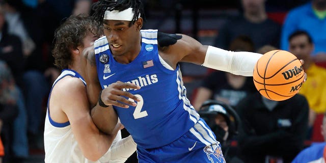 Memphis center Jalen Duren (2) drives past Boise State forward Tyson Degenhart, left, during the first half of a first round NCAA college basketball tournament game, Thursday, March 17, 2022, in Portland, Ore.