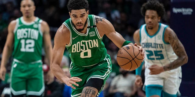 Boston Celtics forward Jayson Tatum (0) leads a fast break during the first half of the team's NBA basketball game against the Charlotte Hornets, Wednesday, March 9, 2022, in Charlotte, N.C.