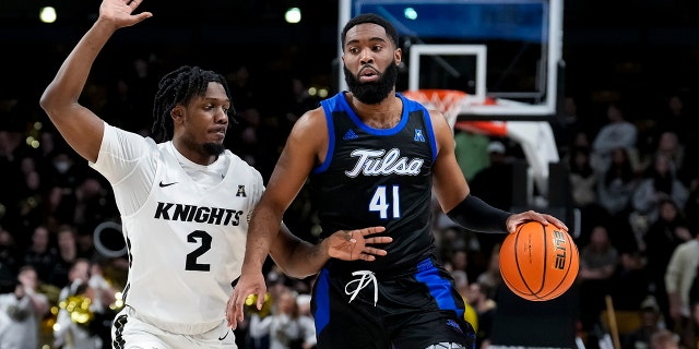 UCF Knights guard Darius Perry (2) and Tulsa Golden Hurricane forward Jeriah Horne (41) during the basketball game between the UCF Knights and the Tulsa Golden Hurricane on Feb. 14, 2022, at Addition Financial Arena in Orlando, Florida.