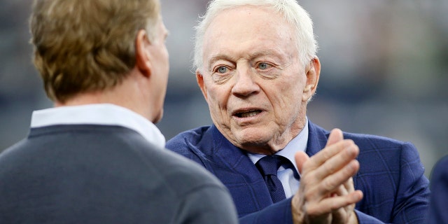 Dallas Cowboys owner Jerry Jones talks (R) with NFL Commissioner Roger Goodell (L) before the game against the San Francisco 49ers in a NFC Wild Card playoff football game at AT&T Stadium on Jan 16, 2022.