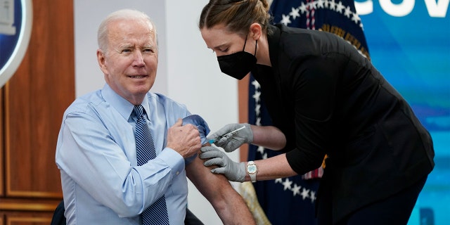 President Biden receives his second COVID-19 booster shot in the South Court Auditorium on the White House campus, Wednesday, March 30, 2022, in Washington.  (AP Photo/Patrick Semansky)