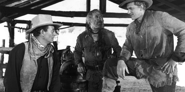 John Wayne, Ward Bond and James Arness on the set of the movie 'Hondo' in 1953.