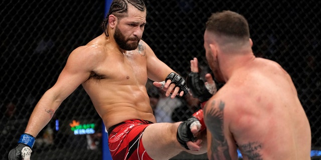 Jorge Masvidal kicks Colby Covington in their welterweight fight during the UFC 272 event on March 05, 2022, in Las Vegas, Nevada.