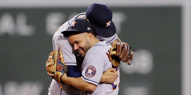 Carlos Correa and Jose Altuve of the Houston Astros celebrate after the Astros defeated the Boston Red Sox in Game 5 of the ALCS at Fenway Park on Wednesday, Oct. 20, 2021, in Boston, Massachusetts.