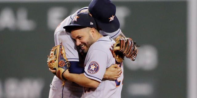 Carlos Correa and Jose Altuve of the Houston Astros celebrate after the Astros defeated the Boston Red Sox in Game 5 of the ALCS at Fenway Park on Wednesday, Oct. 20, 2021, in Boston, Massachusetts.