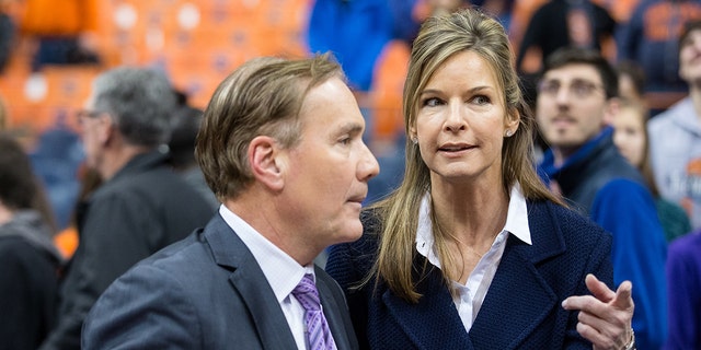 Juli Boeheim, wife of Jim Boeheim, speaks with a member of the ESPNU broadcast team following a basketball game between the Syracuse Orange and the Hampton Pirates on November 16, 2014 at the Carrier Dome in Syracuse, New York .  Syracuse defeated Hampton 65-47. 